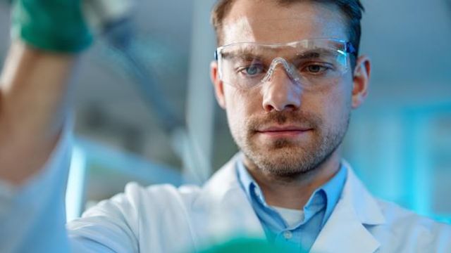 Portrait Of A Scientist Using A Pipette for Filling Test Tube  