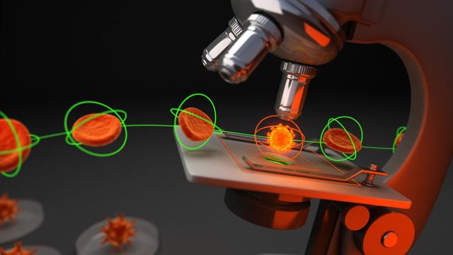 Microscope examining glowing cells to illustrate live-cell analysis in drug discovery. 