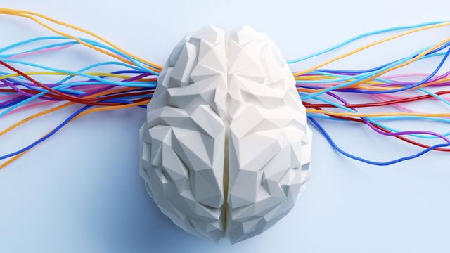 A white 3D rendering of a brain, with rainbow strings behind it. 