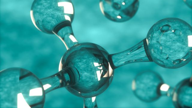 Close up of a molecule against a turquoise background. 