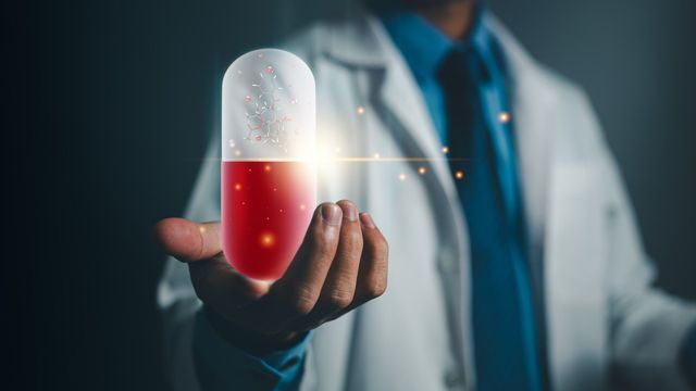 A scientist in a lab coat presenting a hologram of a pill that symbolizes AI in drug toxicity research. 